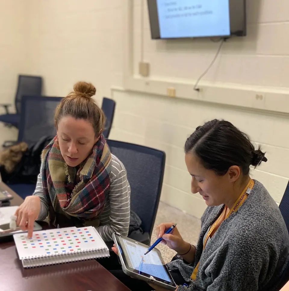 Two school psychologists reviewing student data together